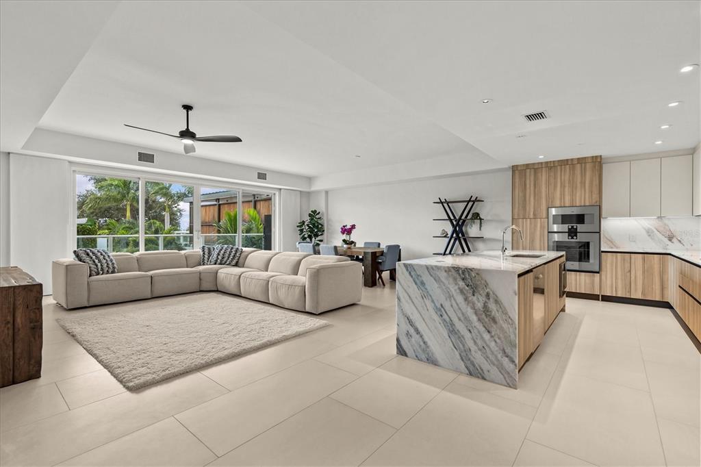 1020 Sunset Point Road, Unit 108 Clearwater, FL 33755 - Photo 8 of 62 a living room with furniture and a large window