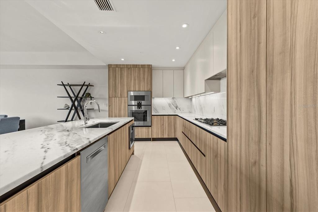 1020 Sunset Point Road, Unit 108 Clearwater, FL 33755 - Photo 9 of 62 a kitchen with stainless steel appliances granite countertop a sink and cabinets
