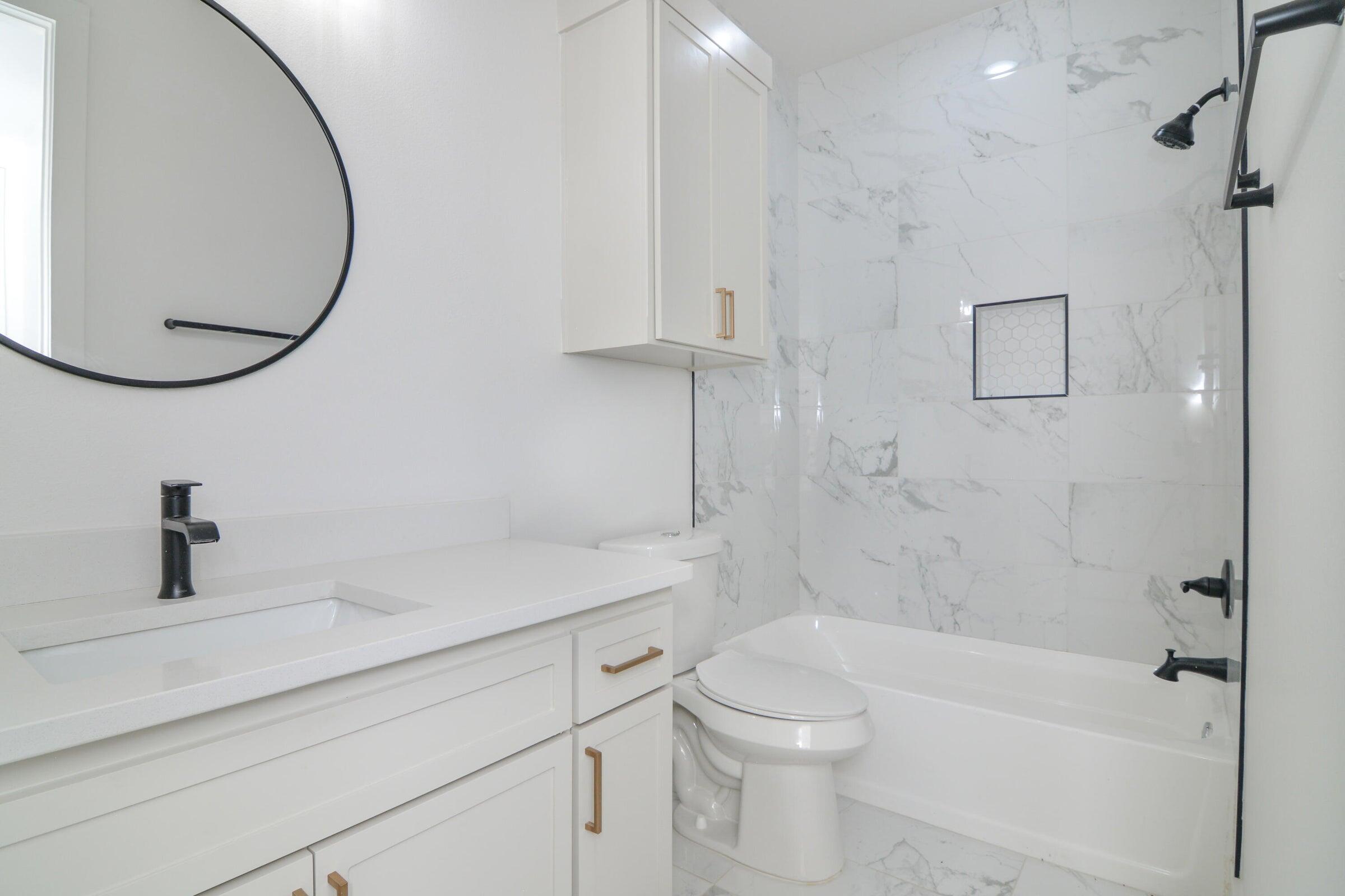 7801 56th Street Lubbock, TX 79407 - Photo 22 of 29 a bathroom with a sink a toilet and shower