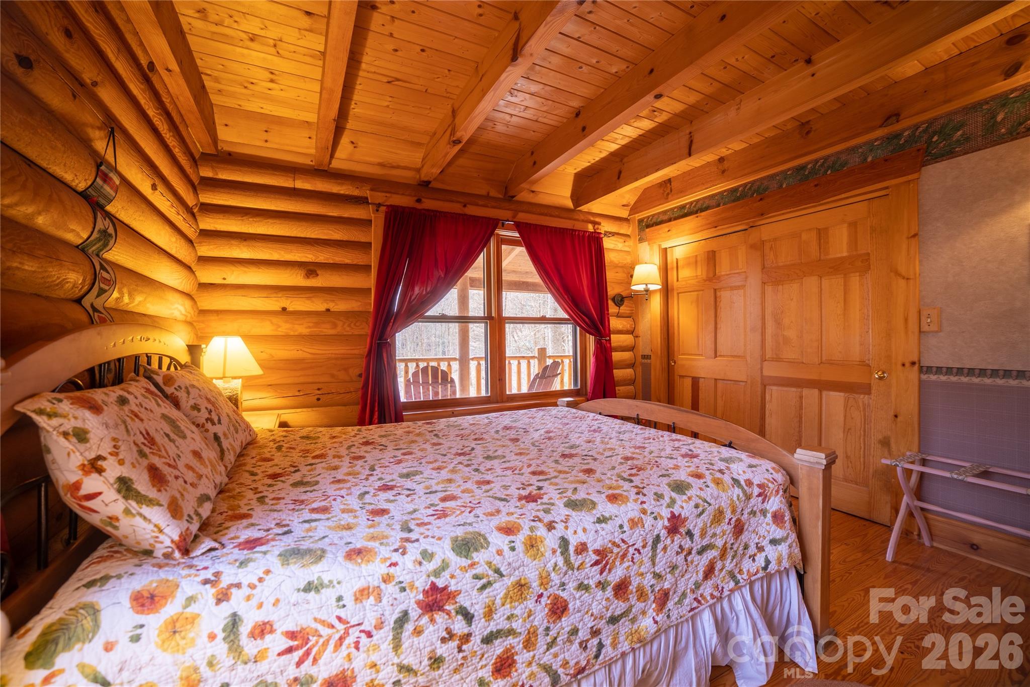 682 Rock House Road Hot Springs, NC 28743 - Photo 20 of 43 a bed sitting in a bedroom next to a window