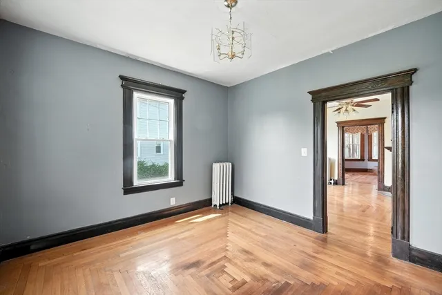 a view of a livingroom with a window and wooden floor