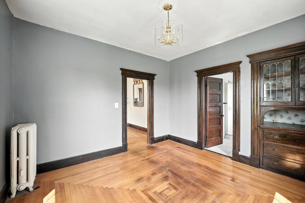 36 Maple Terrace West Springfield, MA 01089 - Photo 16 of 33 a bedroom with a bed and a chandelier