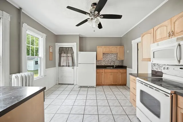 a kitchen with a stove a sink and a microwave