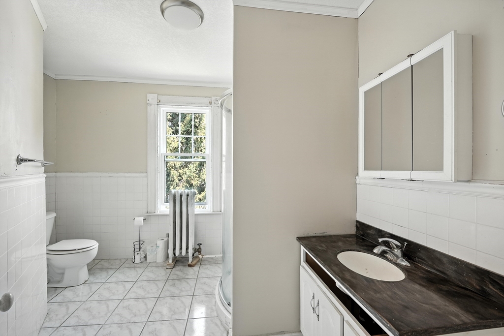 36 Maple Terrace West Springfield, MA 01089 - Photo 33 of 33 a bathroom with a granite countertop sink a toilet and a mirror
