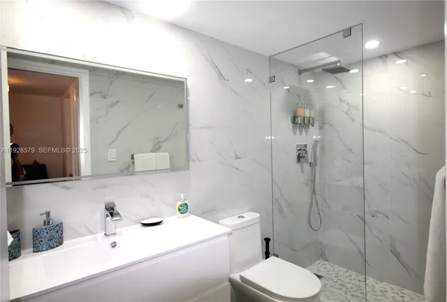 a bathroom with a sink toilet and shower