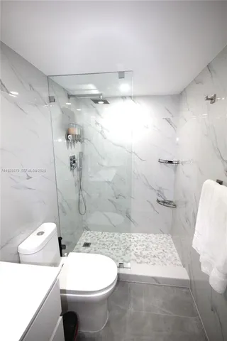 a bathroom with a toilet sink and shower
