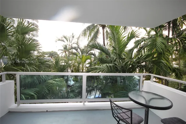 a view of an ocean with palm trees