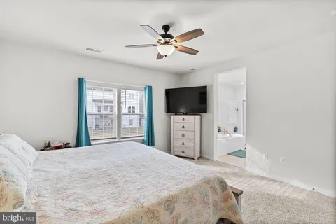 a bathroom with a sink mirror vanity and toilet