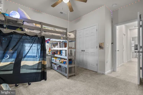 a bedroom with a bed and a desk