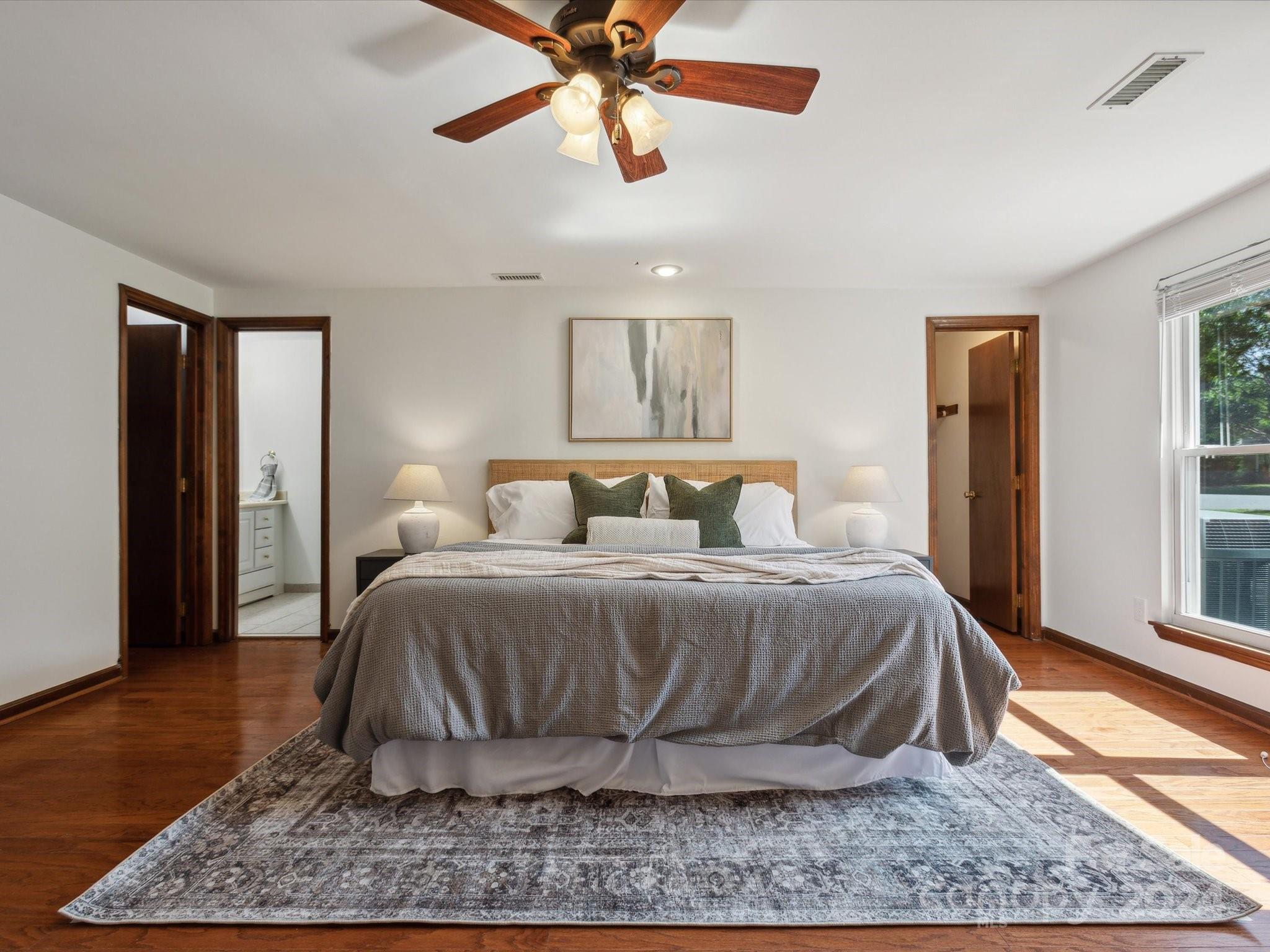 10039 Fairway Ridge Road Charlotte, NC 28277 - Photo 15 of 28 a bedroom with a bed lamps and wooden floor
