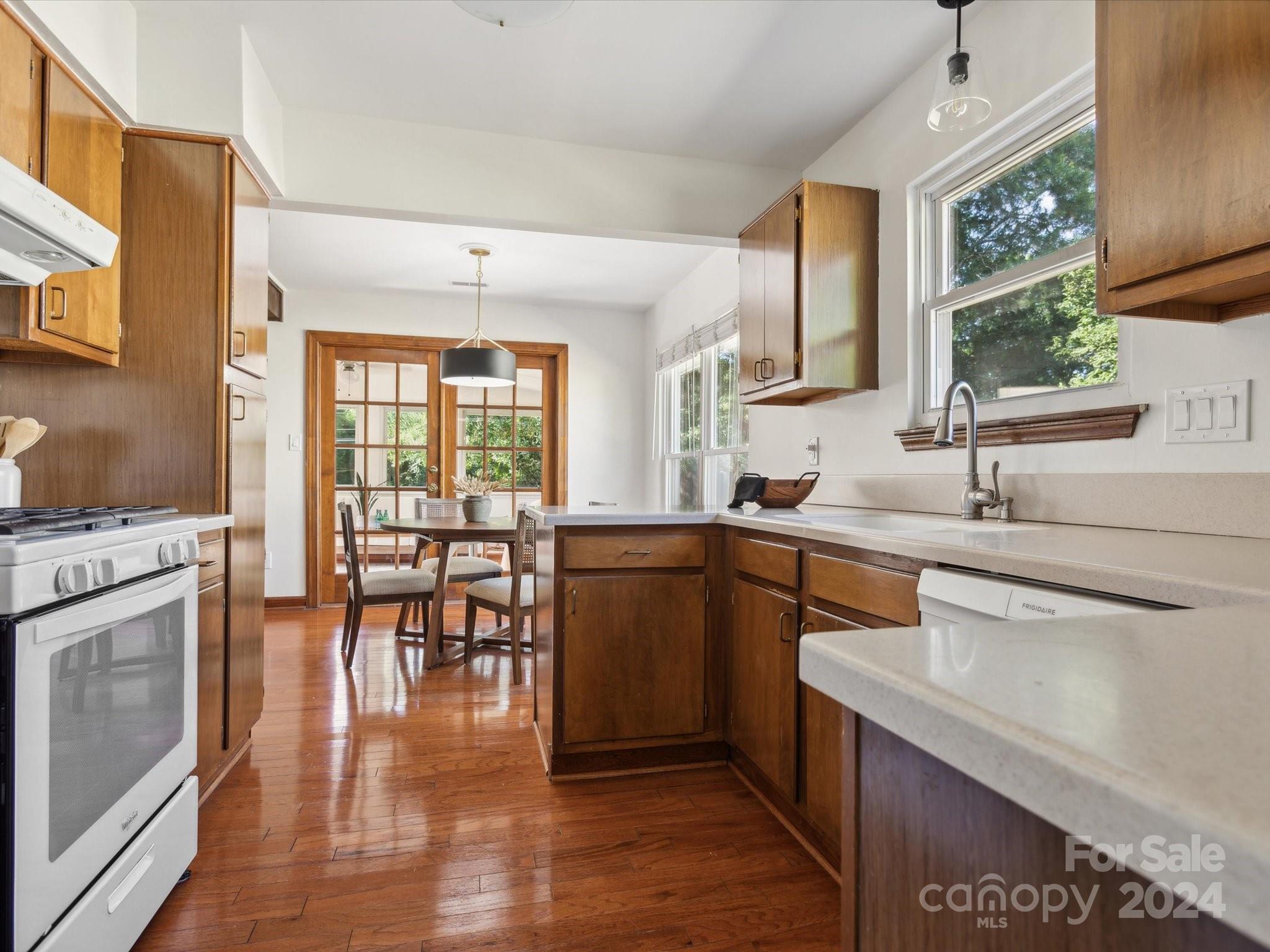 10039 Fairway Ridge Road Charlotte, NC 28277 - Photo 17 of 28 a kitchen with sink cabinets and wooden floor