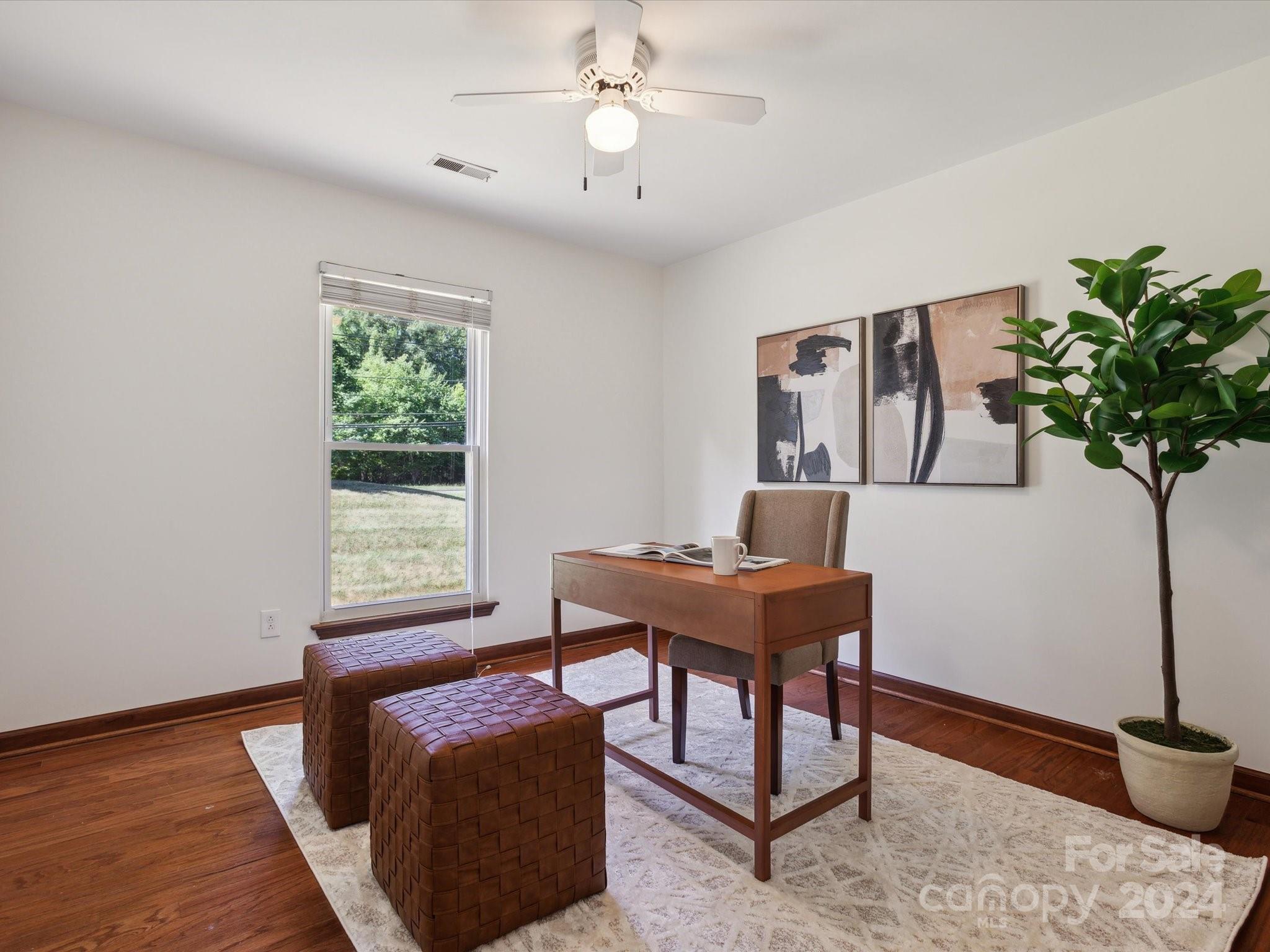 10039 Fairway Ridge Road Charlotte, NC 28277 - Photo 23 of 28 a view of a workspace with furniture and a potted plant