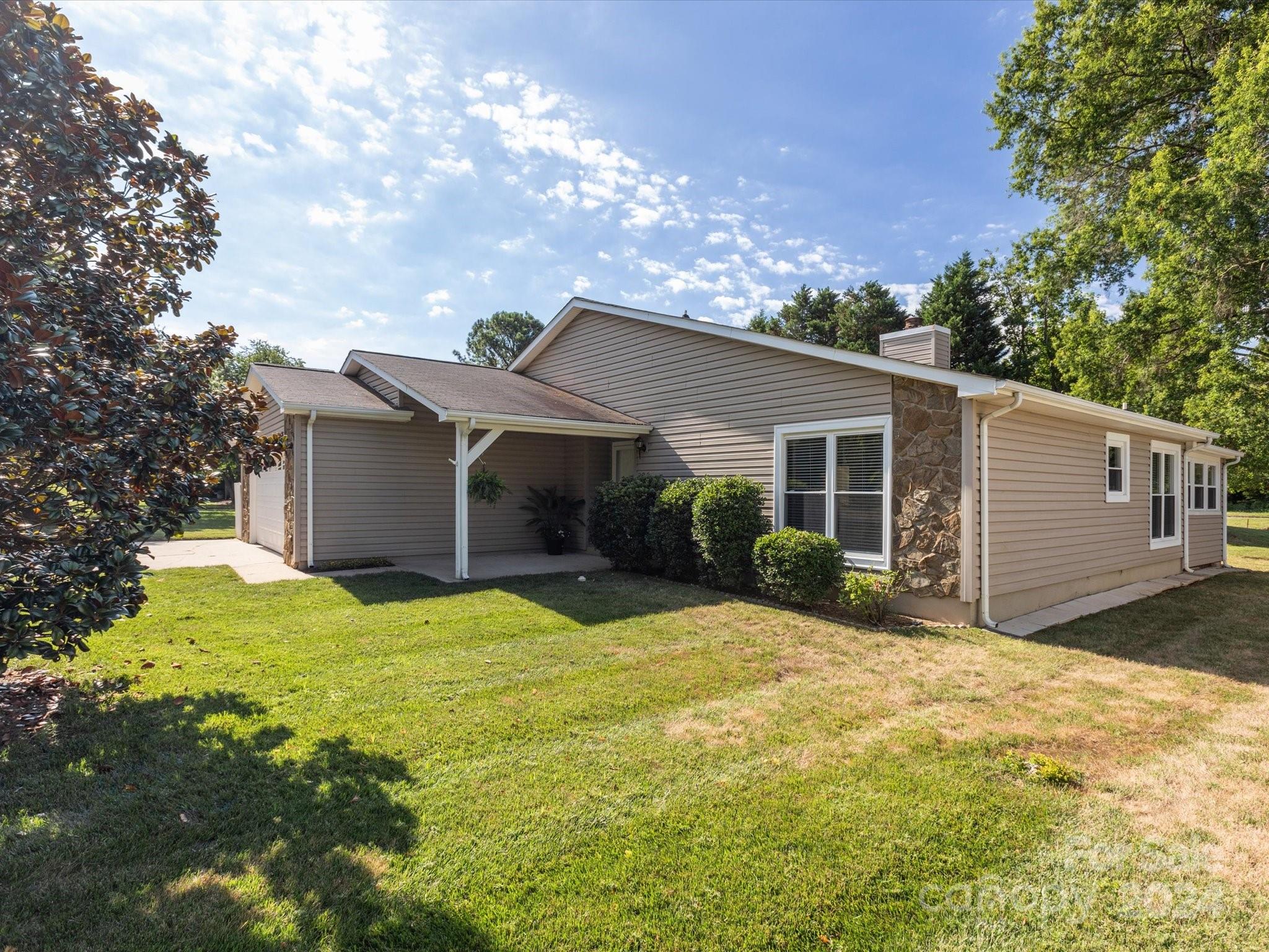 10039 Fairway Ridge Road Charlotte, NC 28277 - Photo 27 of 28 a view of a house with a yard and garage
