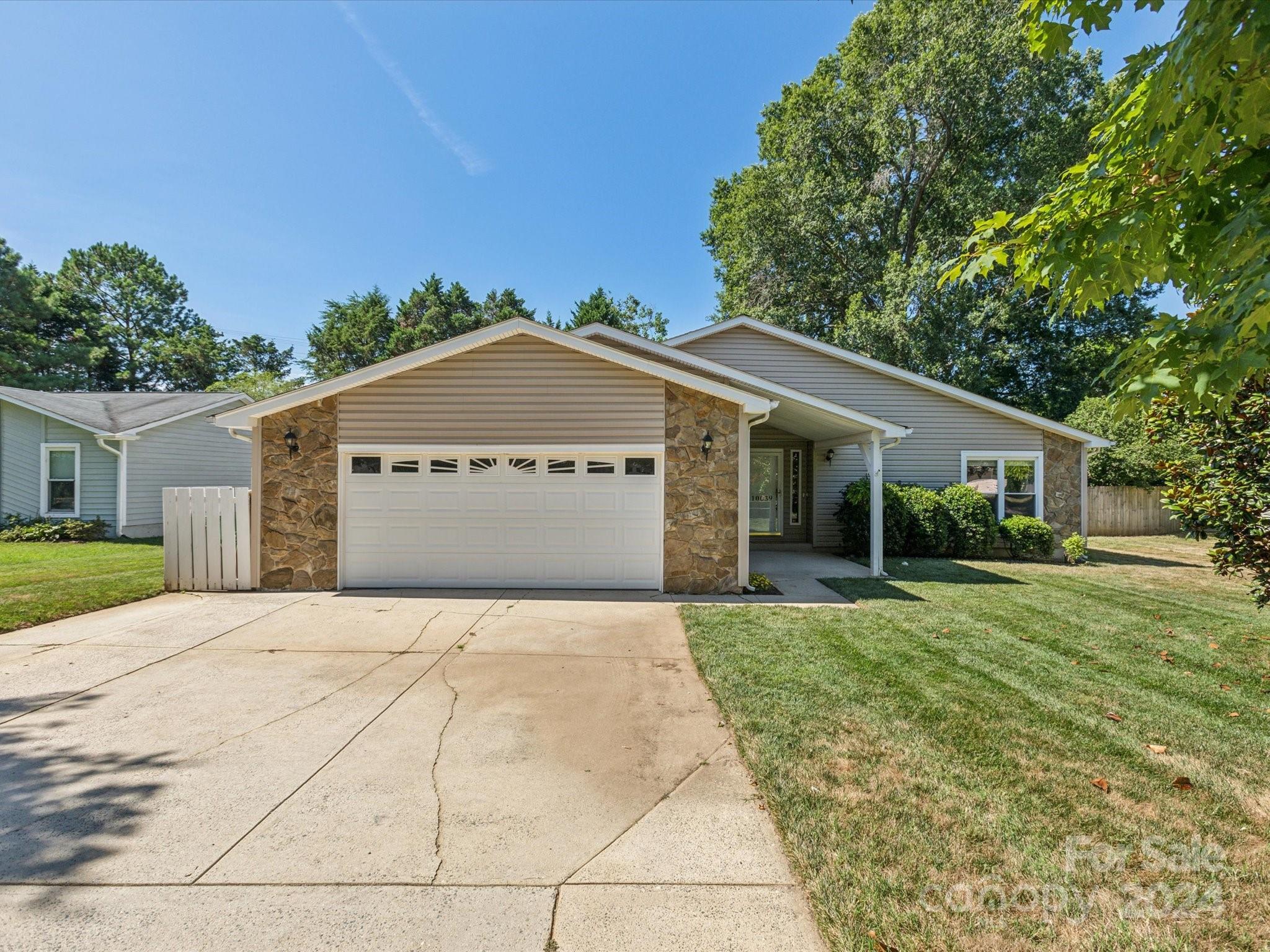 10039 Fairway Ridge Road Charlotte, NC 28277 - Photo 3 of 28 a front view of a house with a yard and garage