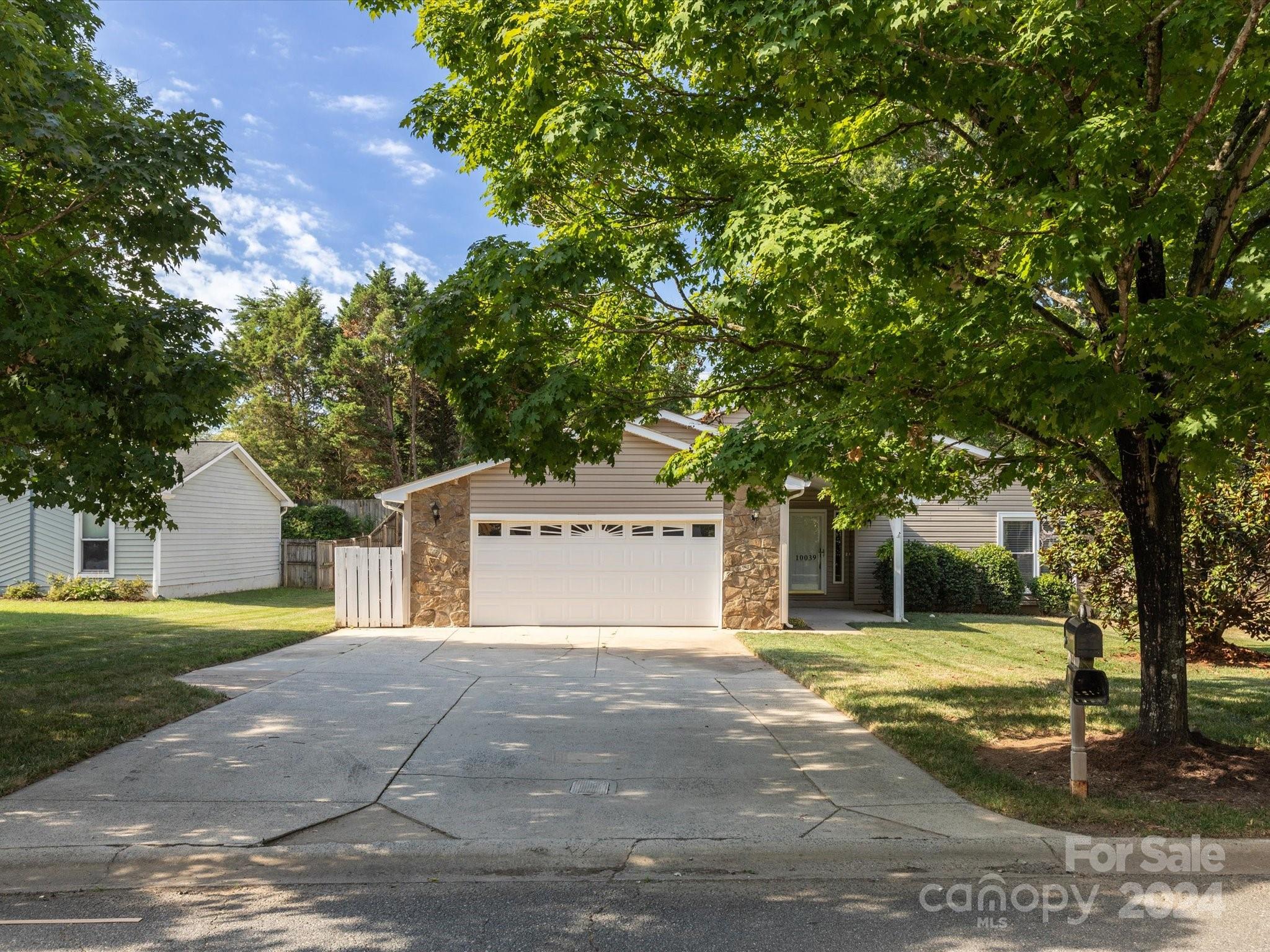 10039 Fairway Ridge Road Charlotte, NC 28277 - Photo 4 of 28 a view of a house with a yard and garage
