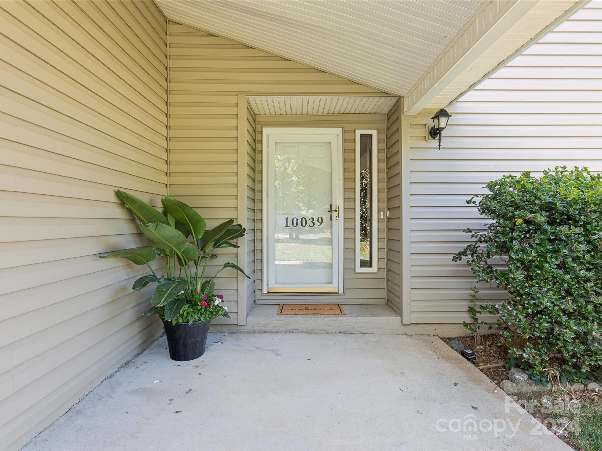 10039 Fairway Ridge Road Charlotte, NC 28277 - Photo 6 of 28 a potted plant sitting in front of a house