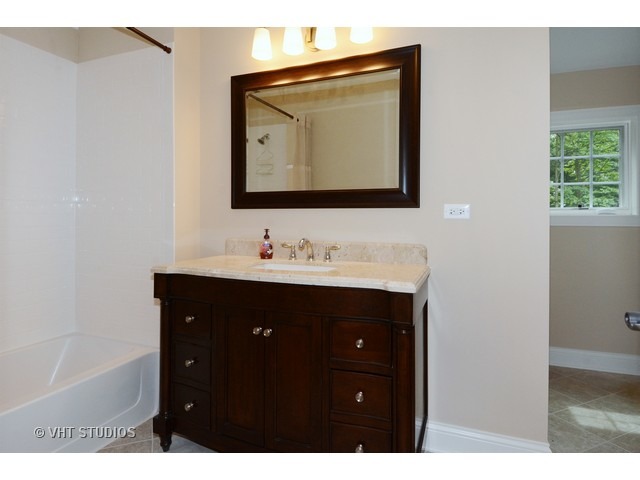 17 P Ashe Road Sugar Grove, IL 60554 - Photo 15 of 17 a bathroom with a sink vanity and mirror