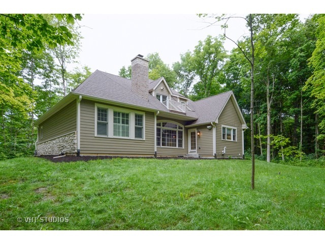 17 P Ashe Road Sugar Grove, IL 60554 - Photo 16 of 17 a view of a house with a yard and a garden