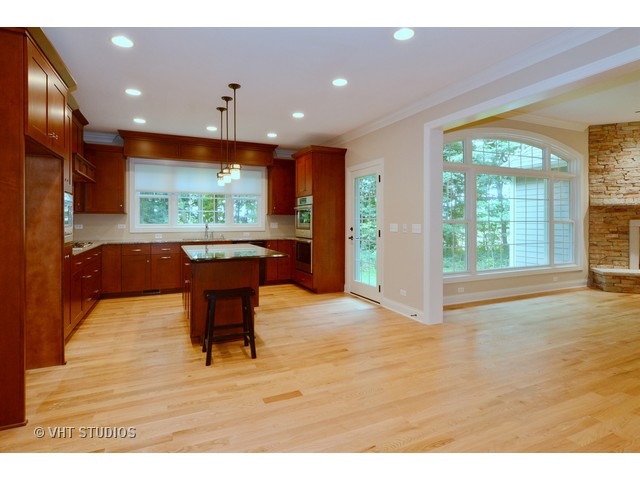17 P Ashe Road Sugar Grove, IL 60554 - Photo 5 of 17 a living room with kitchen island furniture and a flat screen tv