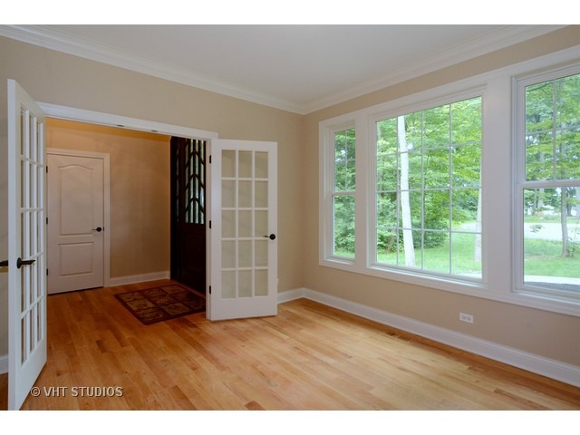 17 P Ashe Road Sugar Grove, IL 60554 - Photo 7 of 17 an empty room with wooden floor and windows