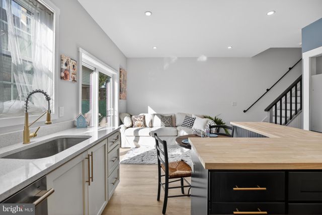 a room with a table chairs and wooden floor