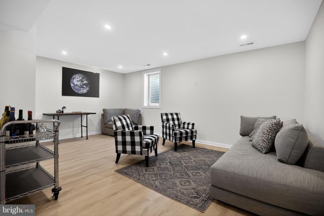 a living room with furniture wooden floor and a flat screen tv