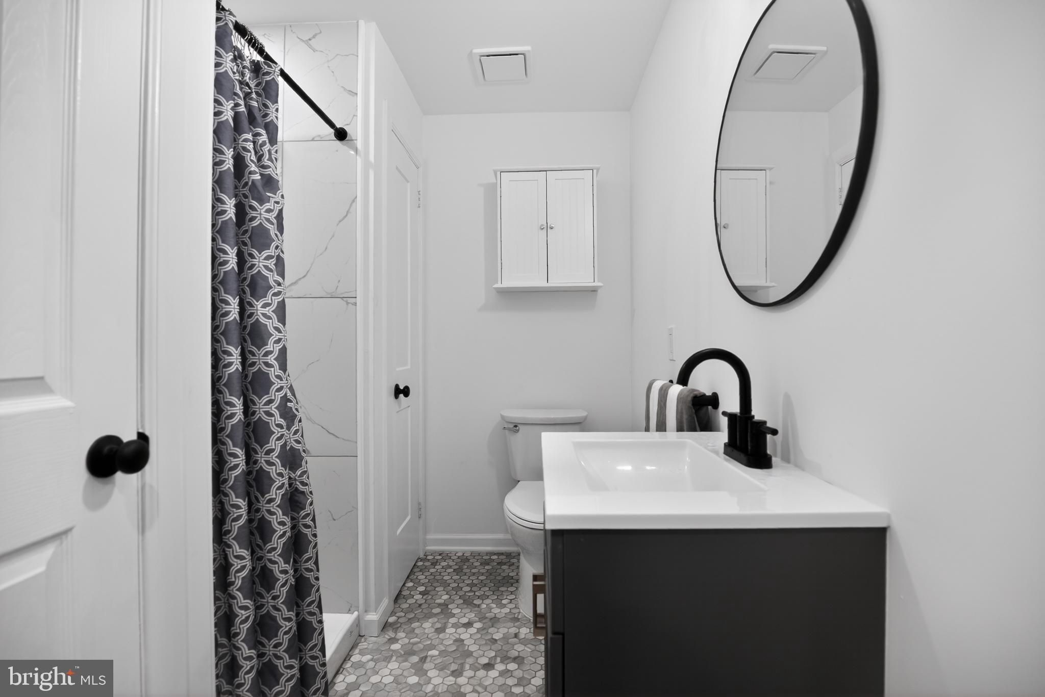 508 Richey Avenue Collingswood, NJ 08107 - Photo 21 of 40 a bathroom with a sink a toilet and a mirror