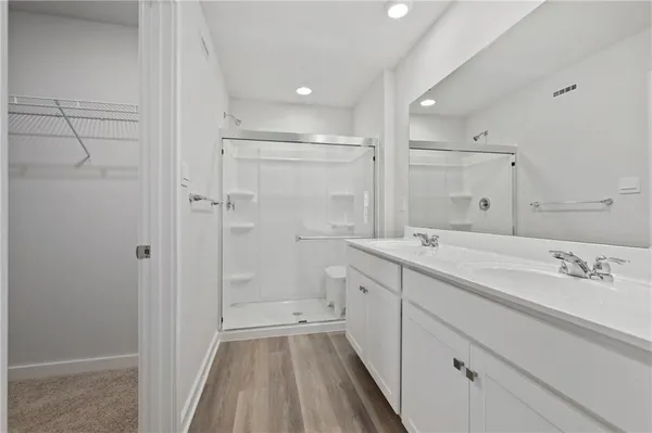 a spacious bathroom with a shower sink and mirror