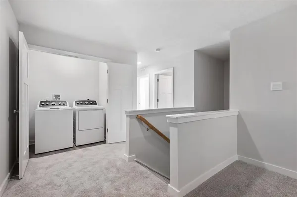 a utility room with cabinets washer and dryer