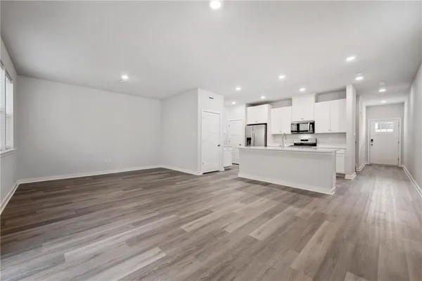 a view of kitchen with wooden floor and window
