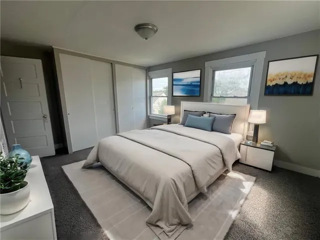 a bedroom with a large bed and a potted plant