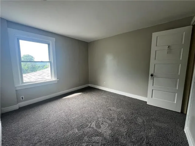 an empty room with a empty space and a window