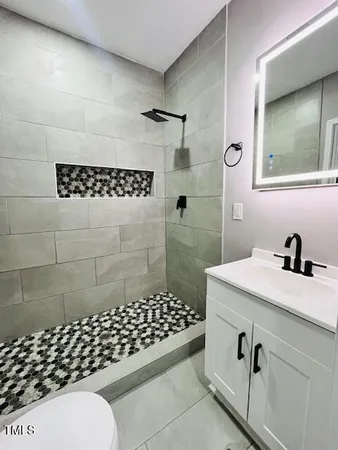 a bathroom with a toilet a sink and a shower