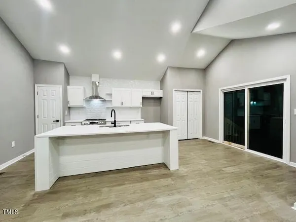 a view of kitchen with stainless steel appliances granite countertop a sink and a refrigerator