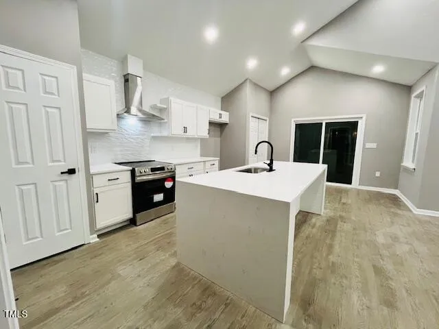 a kitchen with kitchen island a sink stainless steel appliances and cabinets