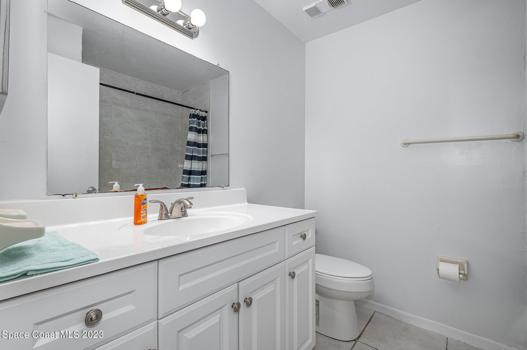 1041 June Drive Melbourne, FL 32935 - Photo 9 of 15 a bathroom with a toilet sink and mirror