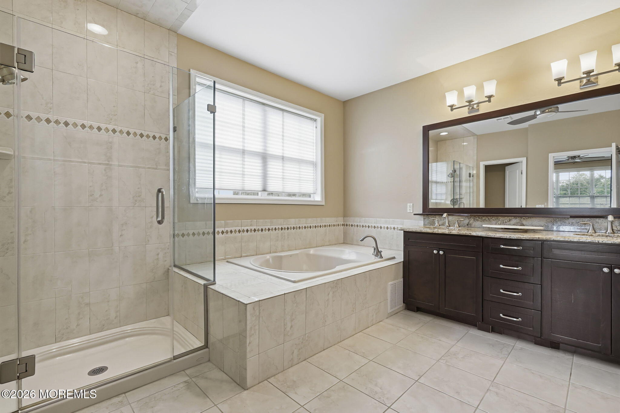 106 Potts Road Morganville, NJ 07751 - Photo 13 of 25 a spacious bathroom with a tub sink shower and mirror