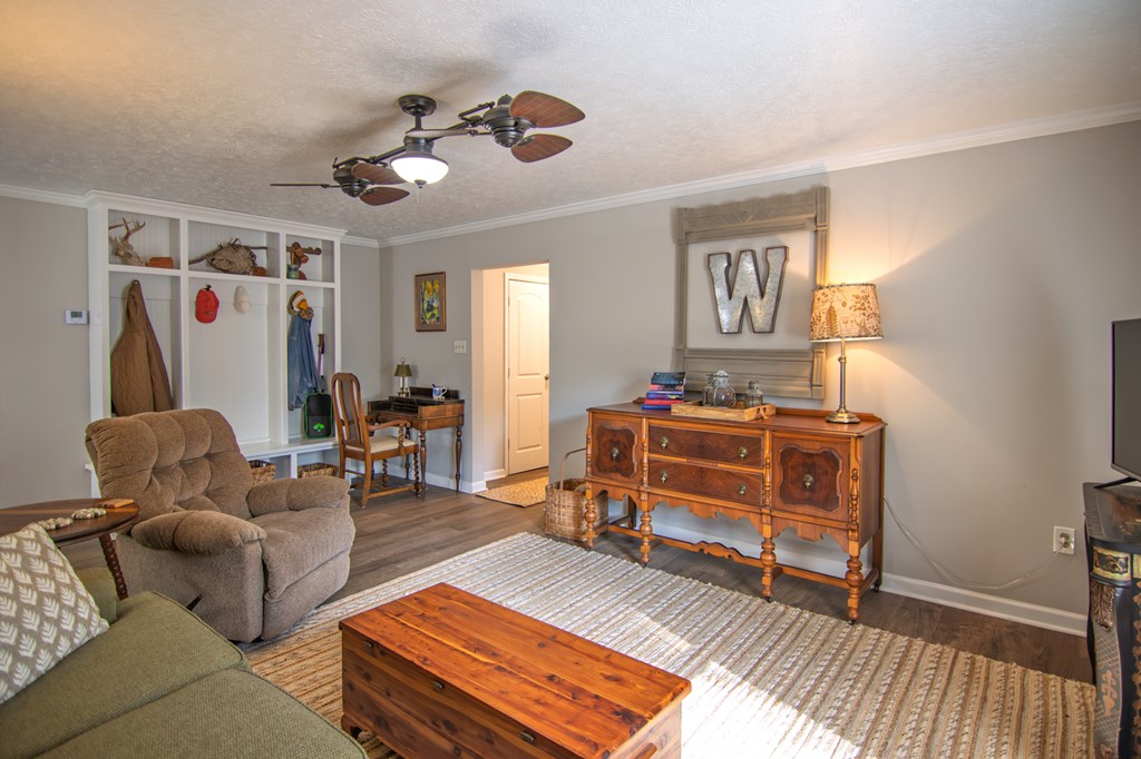10933 Us Highway Hamilton, GA 31811 - Photo 11 of 44 a living room with furniture and a chandelier