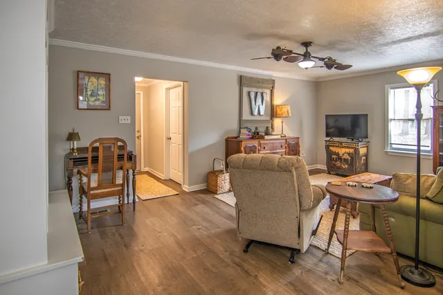 a living room with fireplace furniture and a flat screen tv