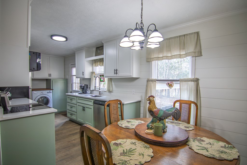 10933 Us Highway Hamilton, GA 31811 - Photo 14 of 44 a kitchen with stainless steel appliances granite countertop a stove a kitchen island a dining table and chairs with wooden floor