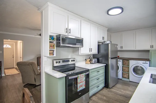 a kitchen with stainless steel appliances granite countertop a refrigerator and a stove top oven