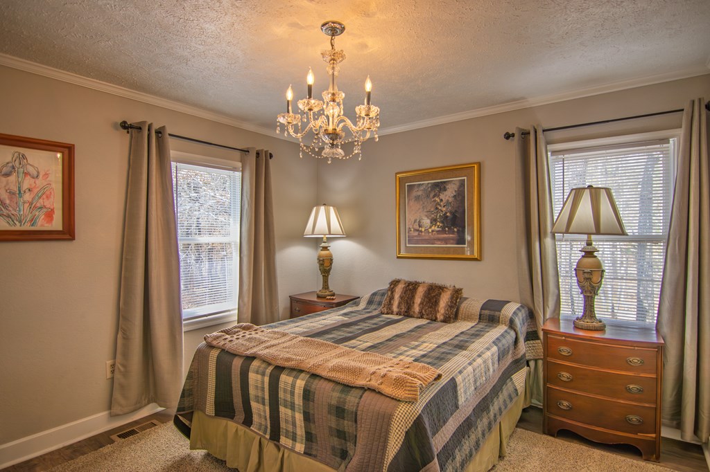 10933 Us Highway Hamilton, GA 31811 - Photo 22 of 44 a bedroom with a bed and a chandelier