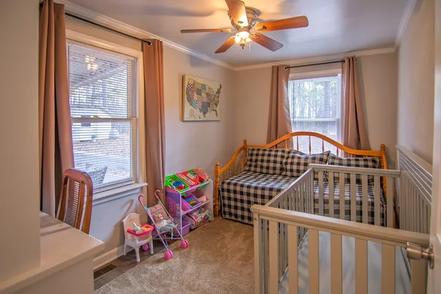 a bedroom with furniture and a window