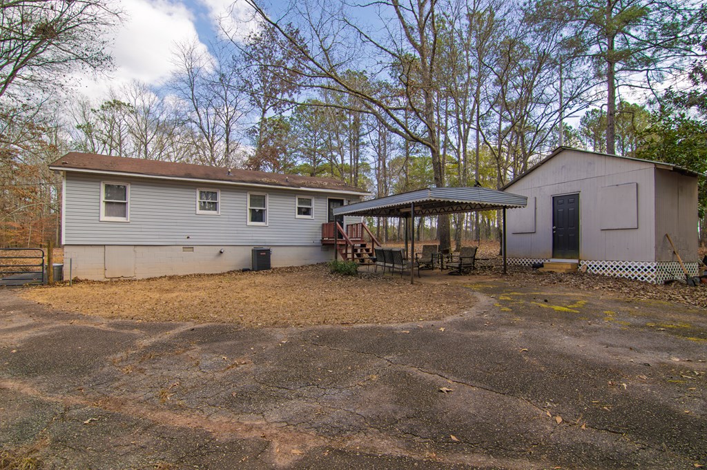 10933 Us Highway Hamilton, GA 31811 - Photo 33 of 44 a front view of house with yard and trees around