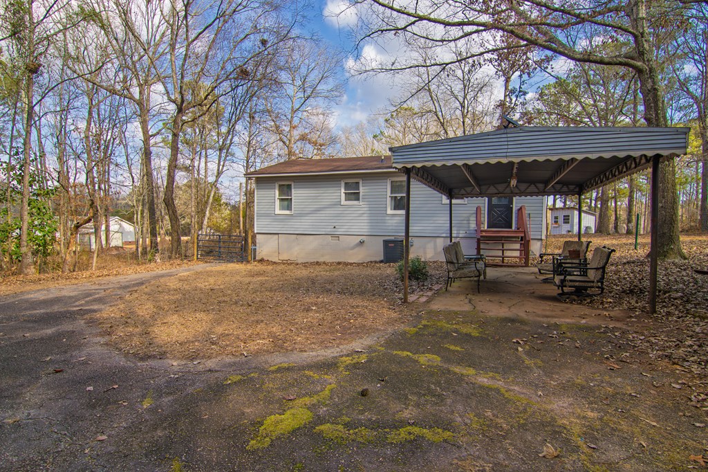 10933 Us Highway Hamilton, GA 31811 - Photo 34 of 44 a view of a house with a large tree and wooden fence