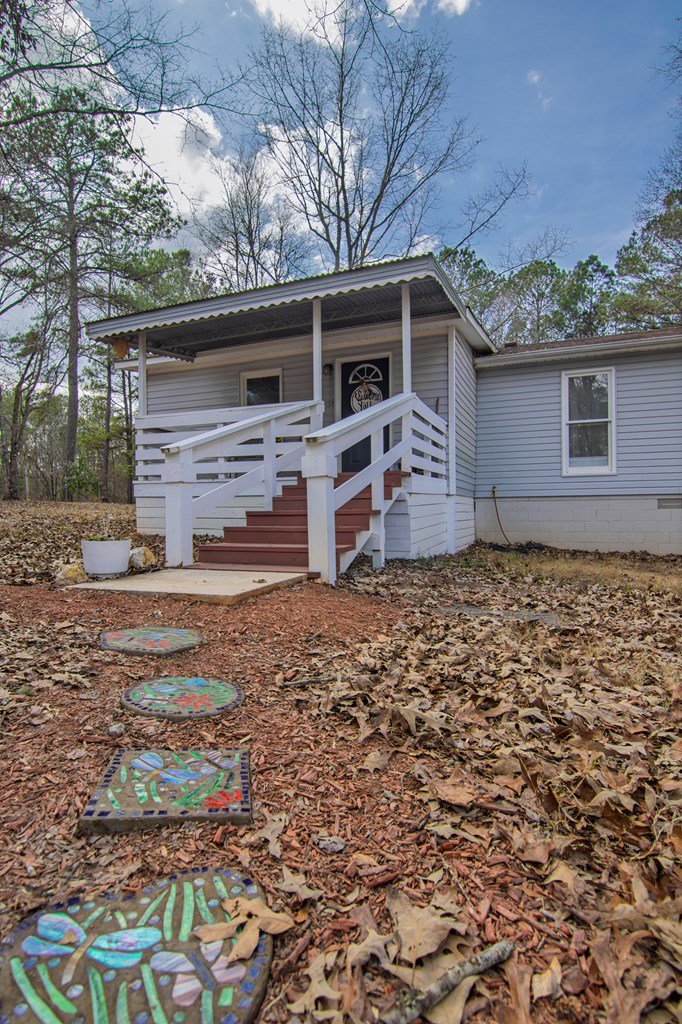 10933 Us Highway Hamilton, GA 31811 - Photo 4 of 44 front view of a house with a yard