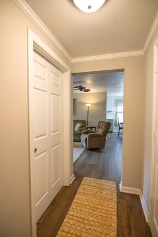 a living room with furniture a flat screen tv and kitchen view