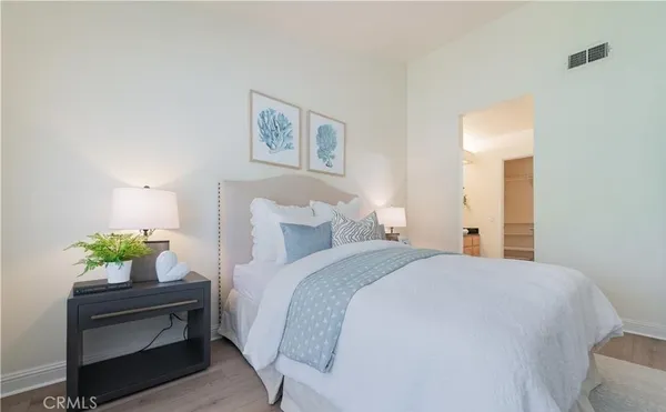 a bedroom with a bed and a potted plant