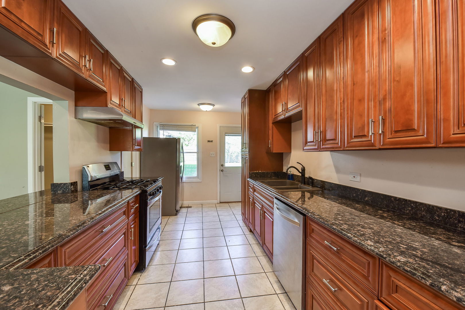 850 Ash Road Hoffman Estates, IL 60169 - Photo 7 of 16 a kitchen with stainless steel appliances granite countertop a stove a sink and a microwave