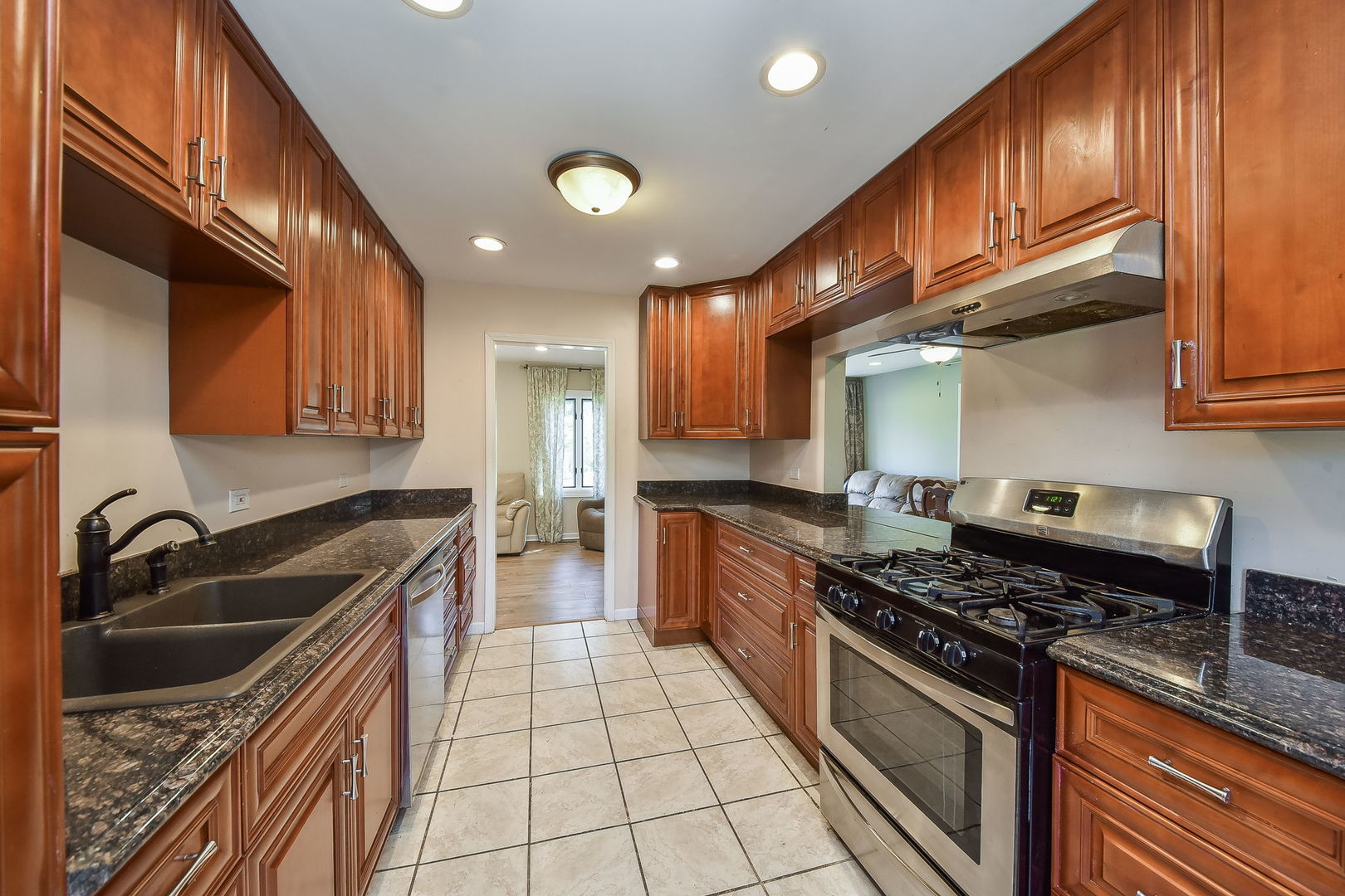 850 Ash Road Hoffman Estates, IL 60169 - Photo 8 of 16 a kitchen with stainless steel appliances granite countertop a sink stove and cabinets